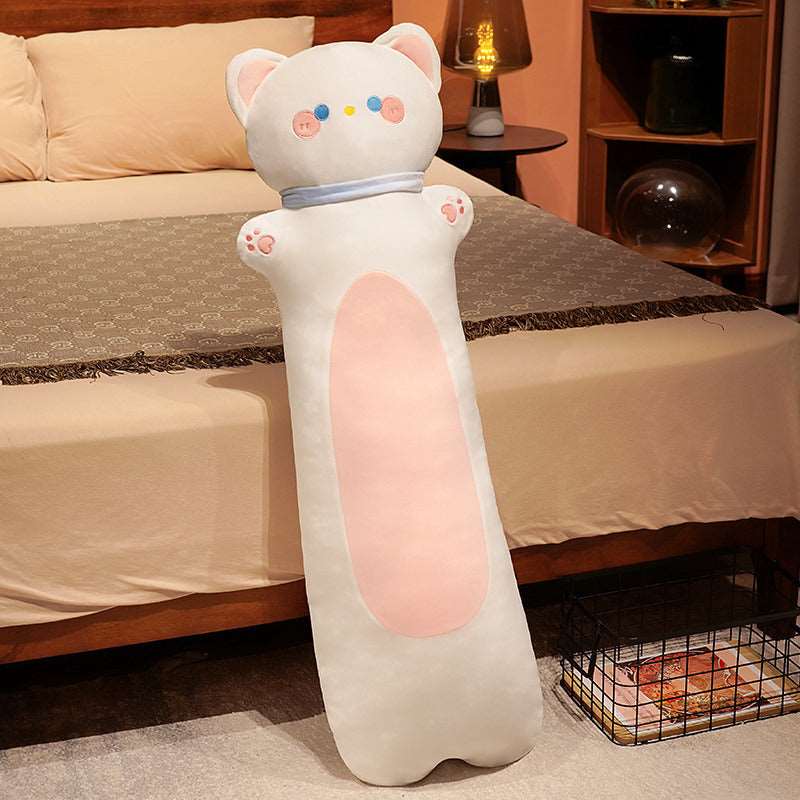Long Snuggle Buddy cat plush displayed by a bed as cozy, decorative cushions.