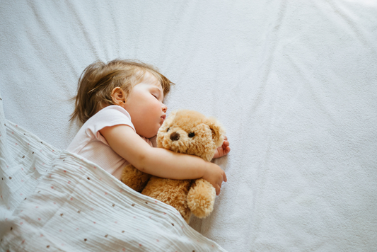 A peaceful scene of a little girl sound asleep, cuddling her beloved teddy bear for comfort and companionship.