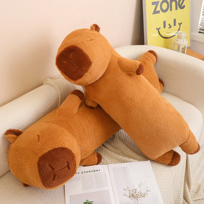 Long Capybara plush stuffed animal displayed on a cozy sofa