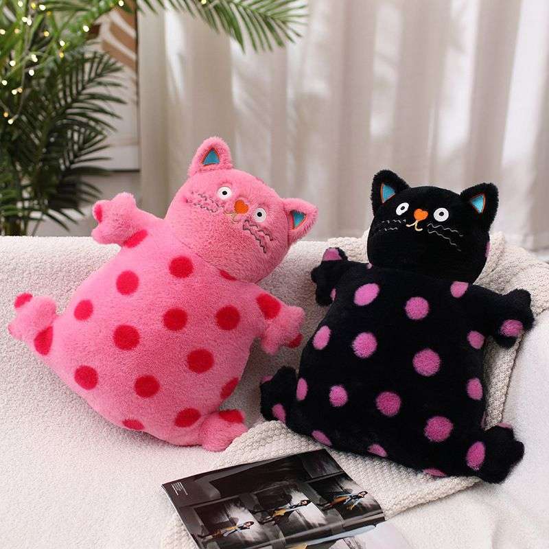 two polka dotted cat plushies