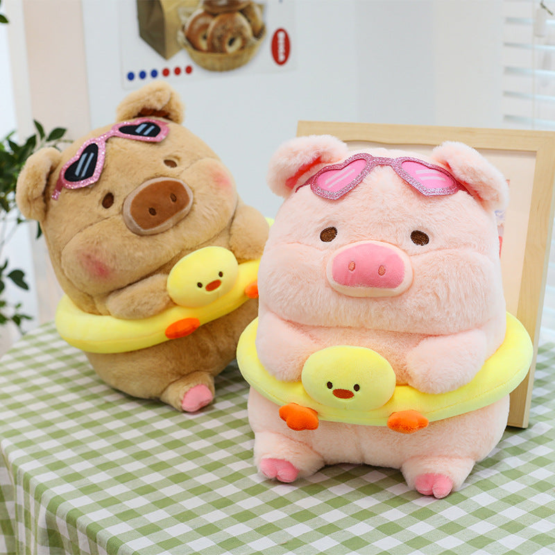 Pink pig plush wearing sunglasses and swim ring
