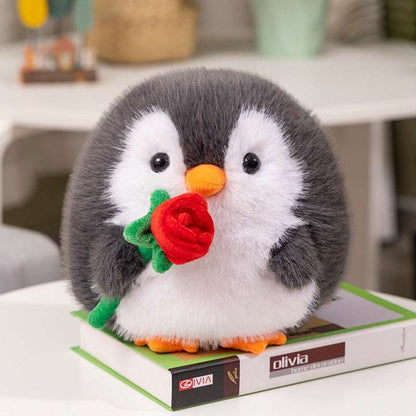 Grey penguin plush holding a red flower
