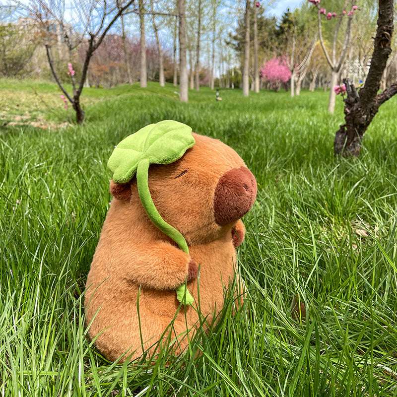 Large capybara plush toy with lotus leaf detail