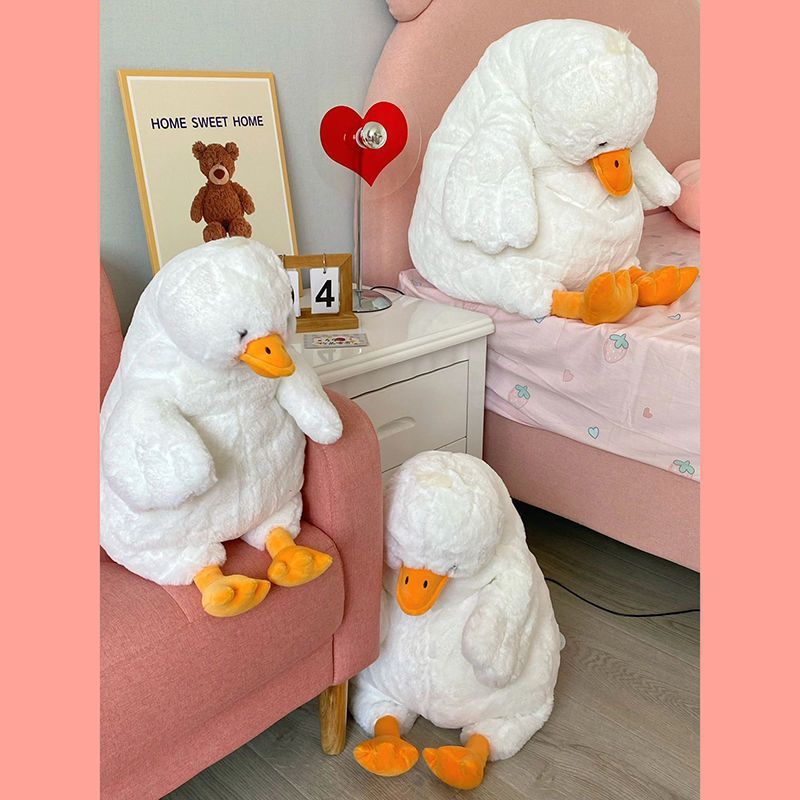Large white duck plushie displayed in bedroom