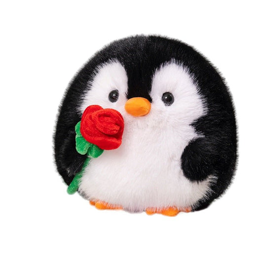 Plush penguin toy holding a red rose on a white background