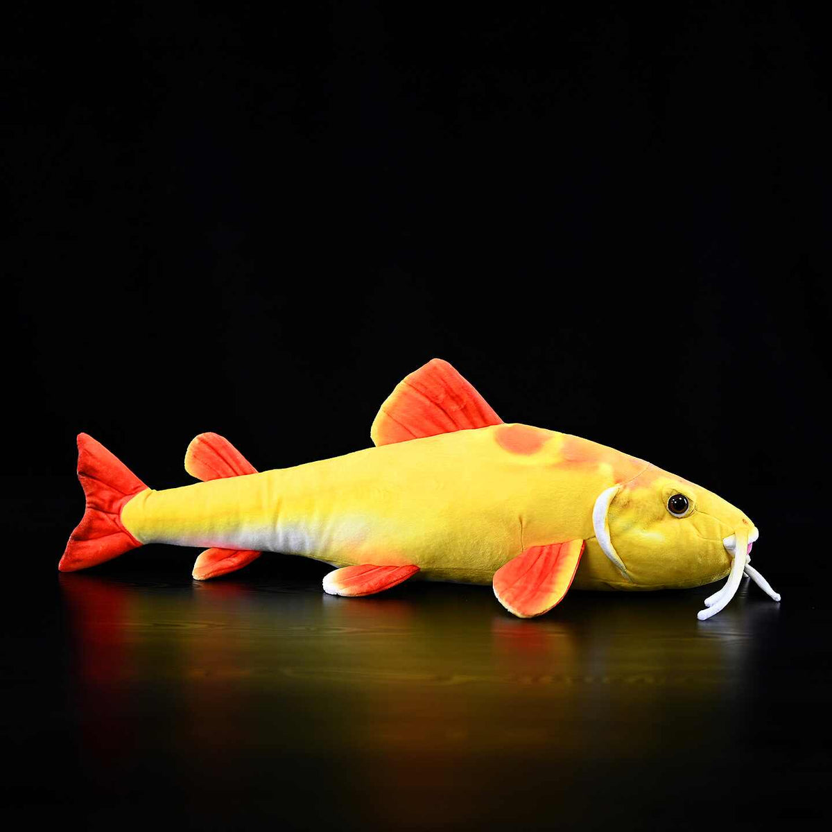 Realistic-style golden catfish plush toy with red tail