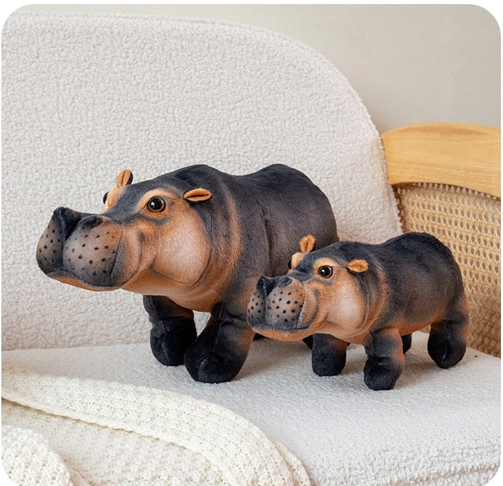 Realistic hippopotamus plush toys displayed together on a cream chair