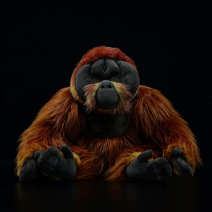 Realistic orangutan plush toy with reddish brown fur
