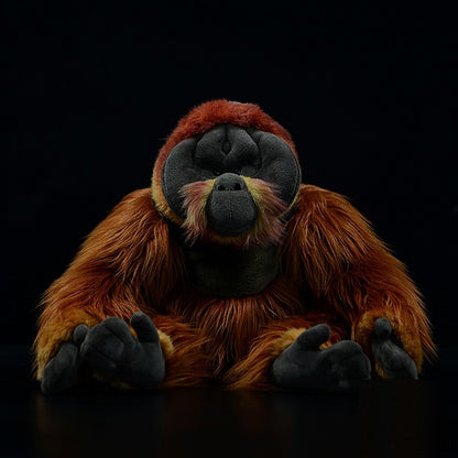 Realistic orangutan plush toy with reddish brown fur