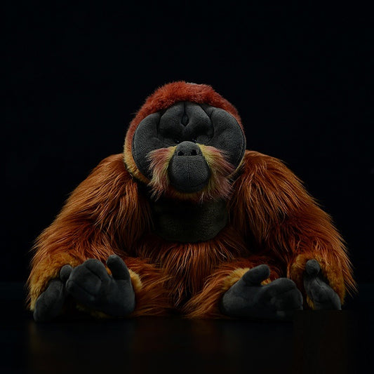 Realistic orangutan plush toy with reddish brown fur