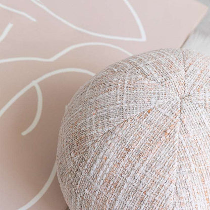 Round ball cushion styled as bedroom or sofa decor