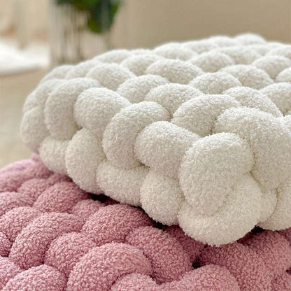Square knot cushion styled in a room setting