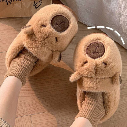 Capybara plush slippers worn indoors on wooden floor