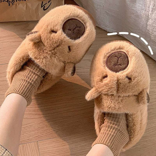Capybara plush slippers worn indoors on wooden floor
