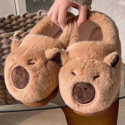 Pair of brown squinty capybara plush slippers close-up