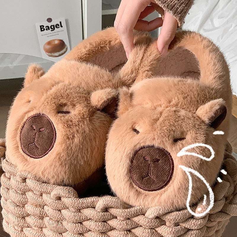 Squinty capybara plush slippers displayed in woven basket