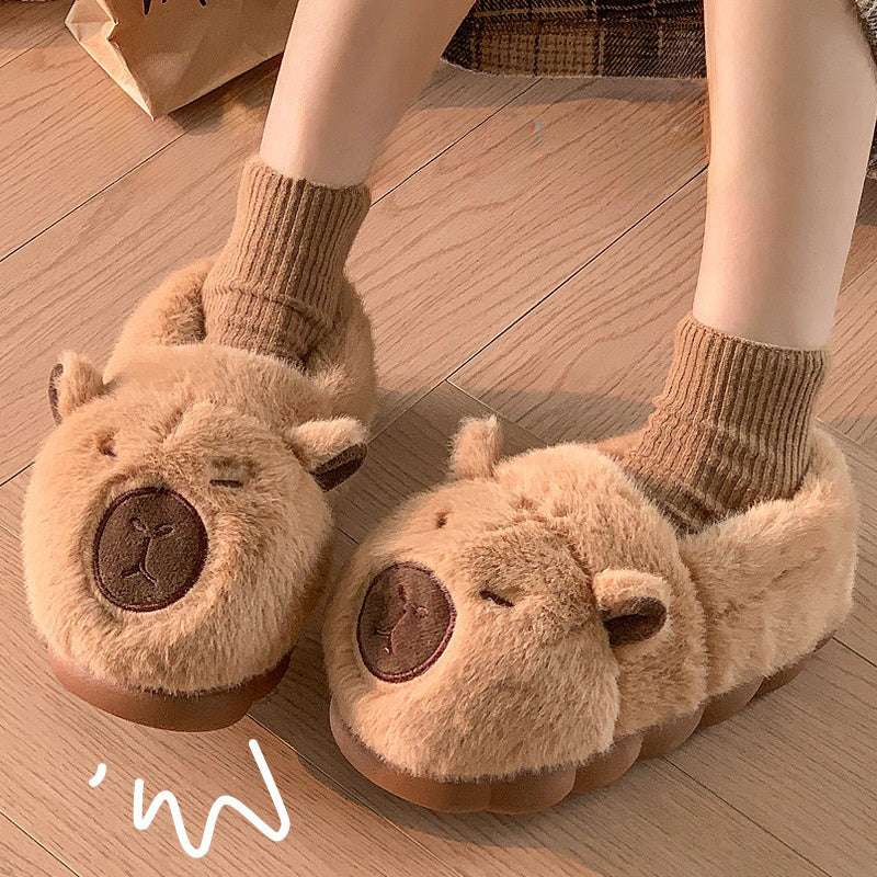 Brown squinty capybara plush house slippers worn indoors