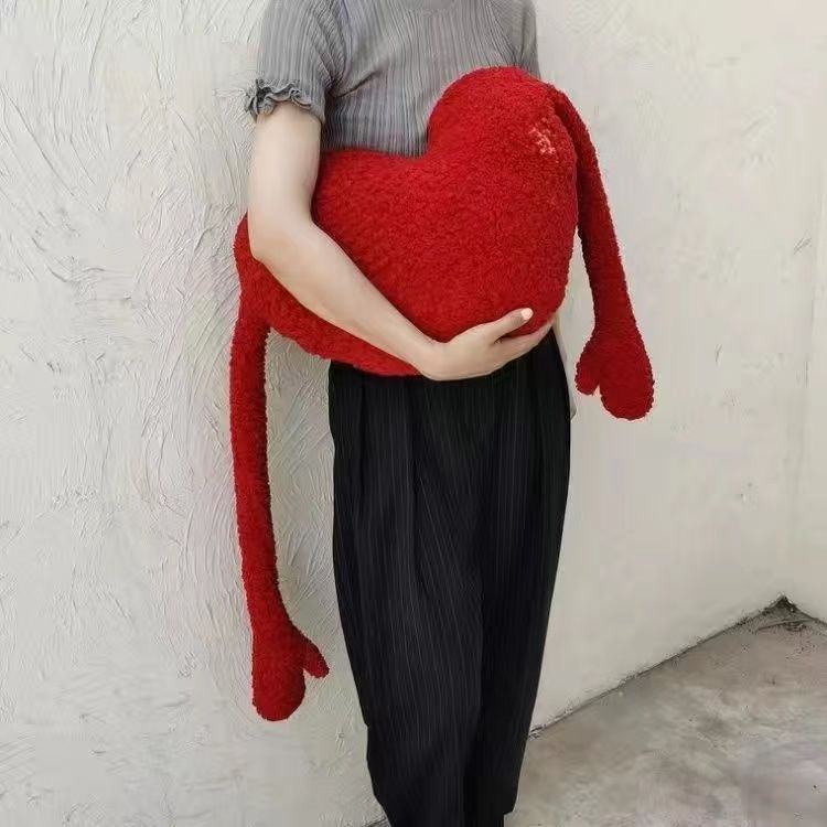 Symmetrical red heart-shaped cushion
