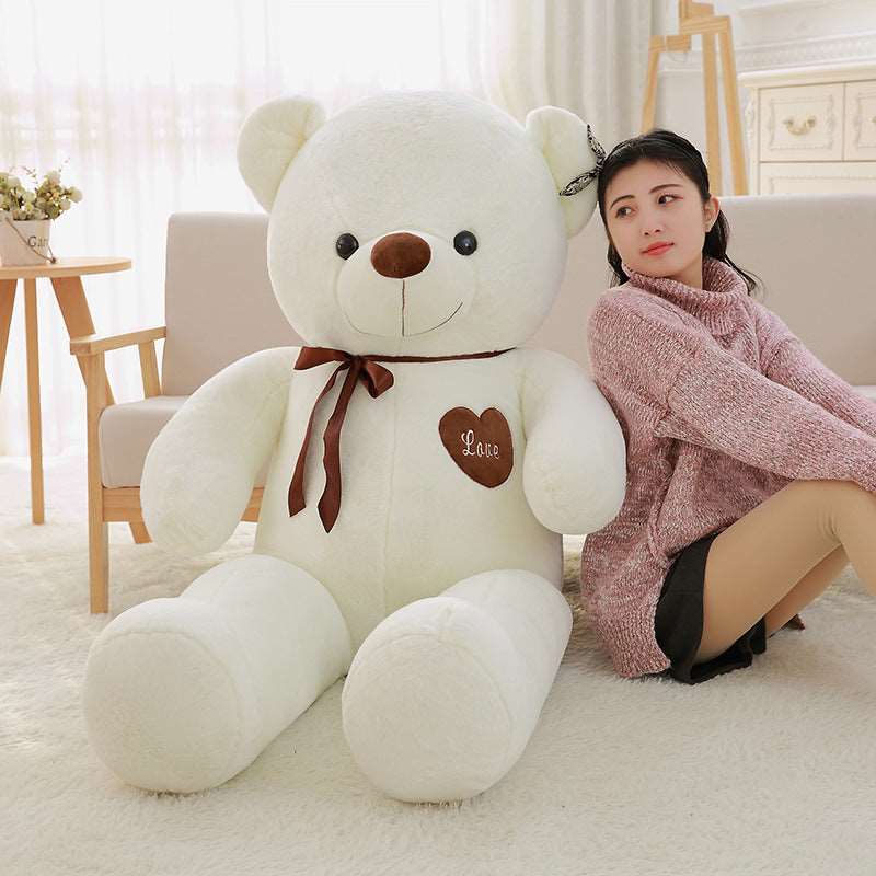 Large teddy bear plush with decorative ribbon detail