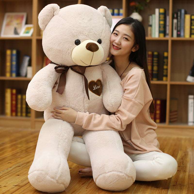 Large teddy bear plush with decorative ribbons